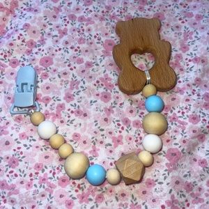Baby teether with natural wood silicone beads with attachment clip.